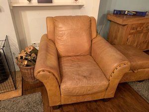 Photo of free Tan leather armchair and footstool (Seahouses, Northumberland)