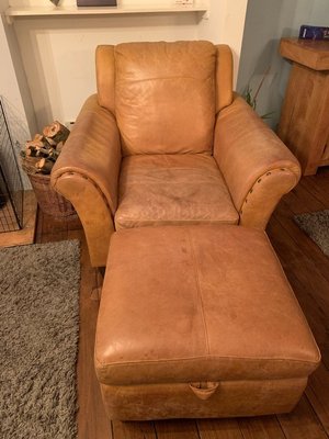 Photo of free Tan leather armchair and footstool (Seahouses, Northumberland)