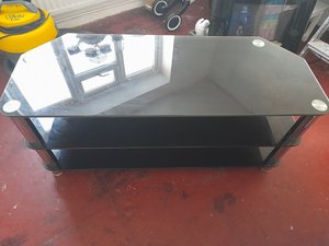 Photo of free Large black glass tv table (Bilborough NG8)