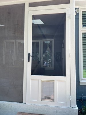 Photo of free Vinyl Screen Door with Pet door (Overland Park, Ks)