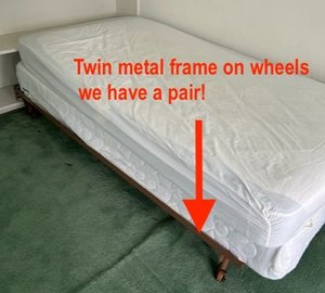 Photo of free Twin bed frames - metal on wheels (NW DC Friendship/Chevy Chase)