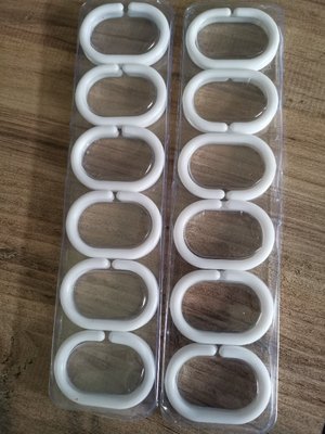 Photo of free 24 white plastic shower curtain rings (Woodley RG5)