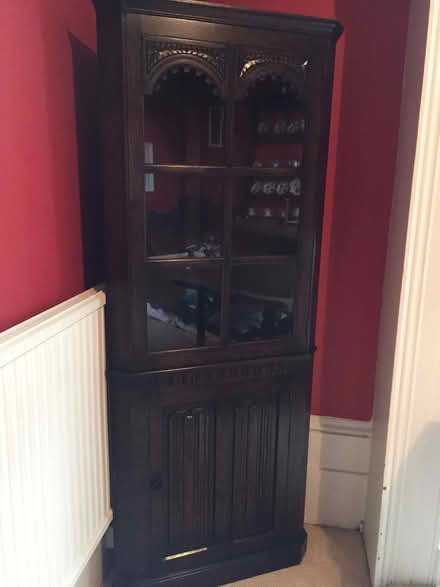 Photo of free Tall glass-fronted dark wood cabinet (Park Central B15) #1