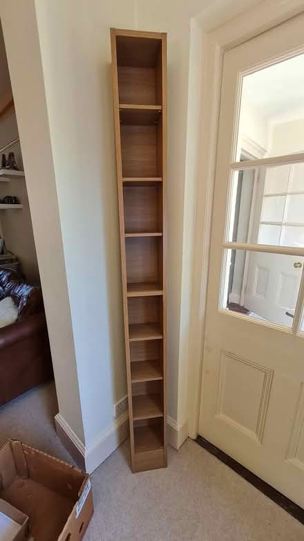 Photo of free Tall skinny book/media shelf (Ashtead) #1