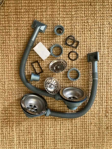 Photo of free Misc double sink drain and plug fittings (E8) #1