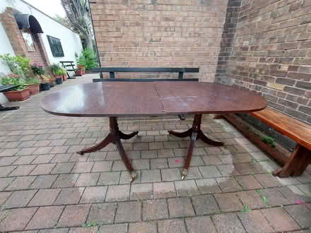Photo of free Large wheeled dining table (Greek Orthodox Church,Dublin 7) #1