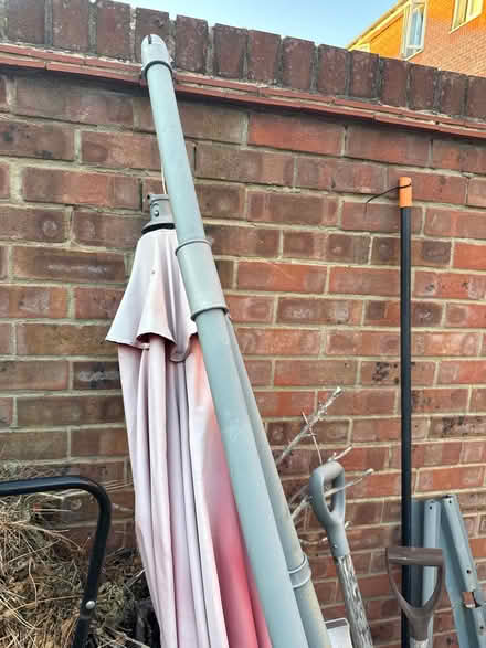 Photo of free Umbrella and one weight for it (Mudchute E14) #2