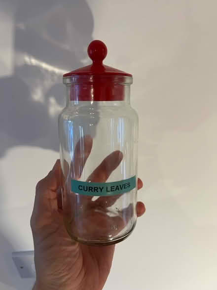 Photo of free Storage jar with red lid (Cove GU14) #1
