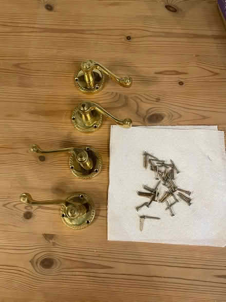 Photo of free 2 brass door handles with screws for fixing (Brigstock NN14) #1