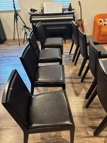 Photo of free 8 black dining chairs- has wear and tear on seat, no structural damage #2