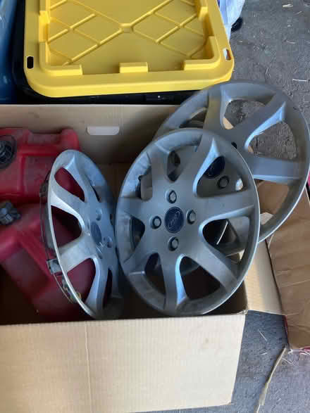 Photo of free Ford Focus hubcaps and 2 gas cans (Lakewood) #1