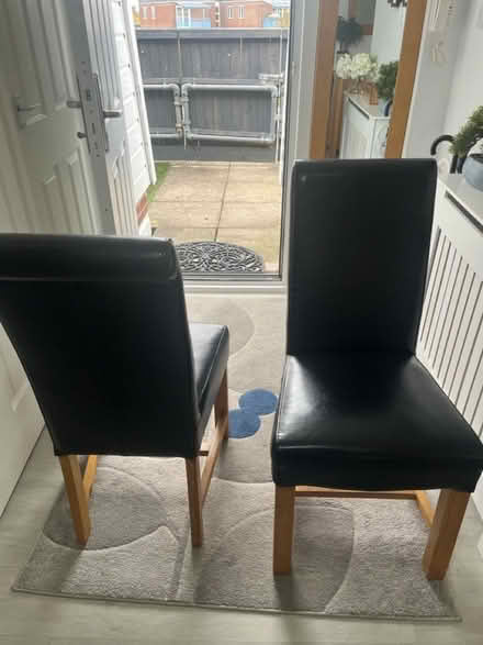 Photo of free Black leather look oak chairs (Welwyn Garden City) #1