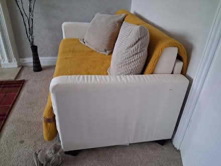 Photo of free White 2 seater sofa bed. Dimensions 55 inch W 32 inch 31 D (The Windmill WS15) #1