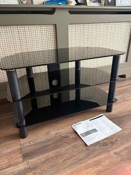 Photo of free Black glass tv stand (Woodham) #1