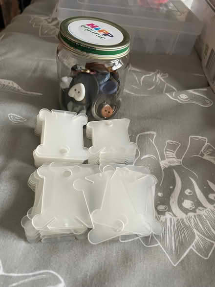 Photo of free Plastic thread bobbins and small jar of buttons (Thringstone LE67) #1