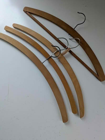 Photo of free 4 wooden coat hangers (Coombe Bissett SP5) #1