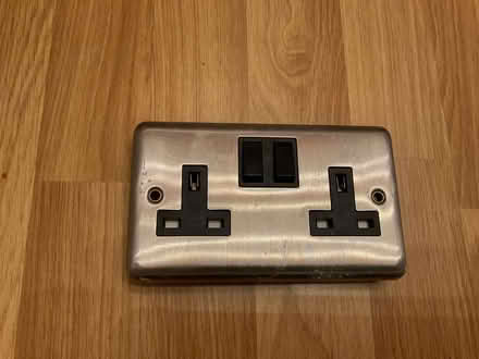 Photo of free Double socket cover - Brushed stainless steel and black. (Garsington OX44) #1