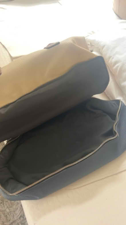 Photo of free Cream and blue duffle bag (Coulsdon town station) #1