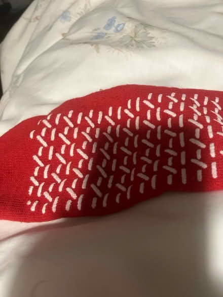 Photo of free red anti slip sock. useful when getting out of bed in the night in excellent condition from pet and smoke free home. (AB15) #1