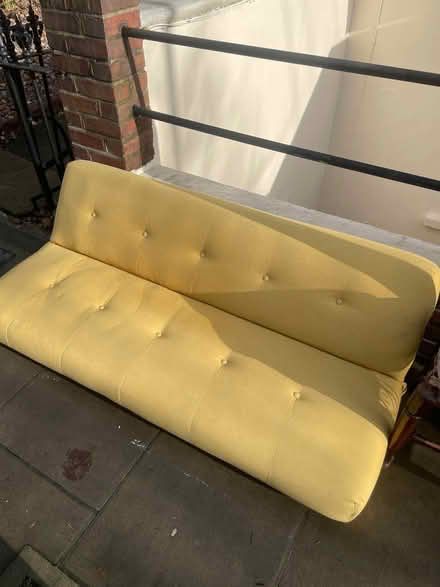 Photo of free Yellow futon (Stoke Newington N16) #1