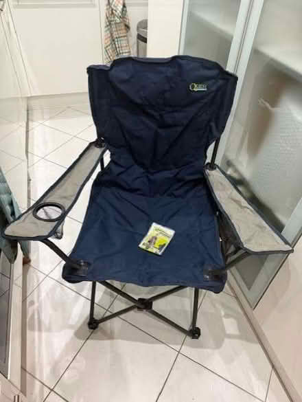 Photo of free New fold up garden chair - never used (and poncho) (Earls Court SW10) #1