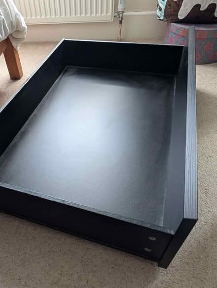 Photo of free Black wooden drawer on wheels for underbed storage (Ikea) (Headington OX3) #1