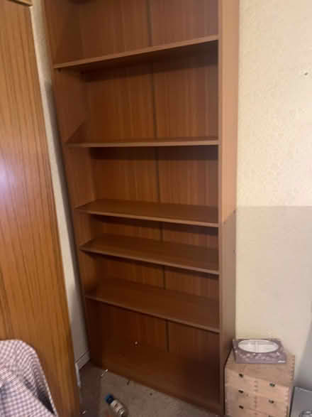 Photo of free Tall teak effect bookcase. 2 vintage wardrobes (Chiswick W4) #1