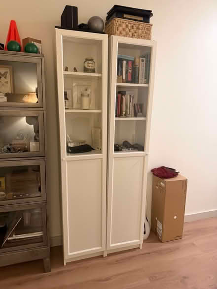 Photo of free Tall shelving unit with glass door (New Rochelle) #2