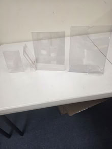 Photo of free bin full of small acrylic sign holders #1