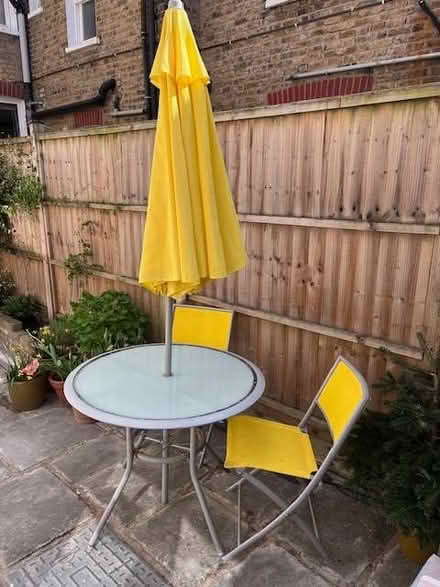 Photo of free Grey round garden table, 4 chairs & parasol (yellow) (Putney SW15) #2