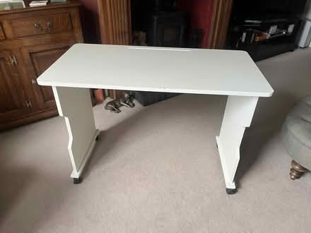 Photo of free White wooden desk on wheels (Woking GU22) #1