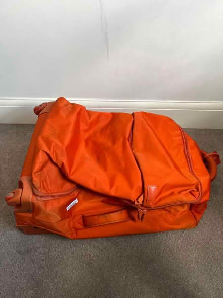 Photo of free Large soft orange suitcase (Guiseley LS20) #1