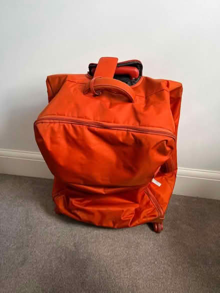 Photo of free Large soft orange suitcase (Guiseley LS20) #2