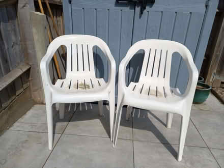 Photo of free 2 white plastic garden chairs (Witney OX28) #1