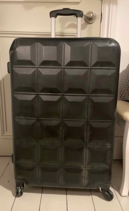 Photo of free Large, black, hard shell suitcase (Custom House E16) #1