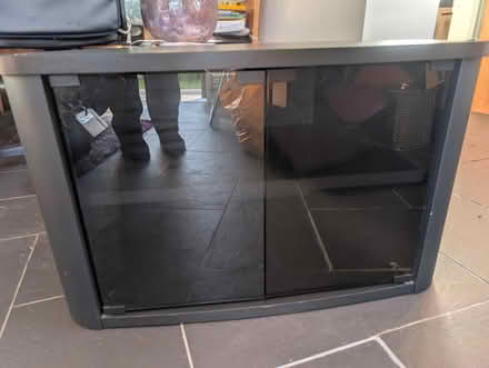 Photo of free Black TV stand with glass doors (Blackpool) #1