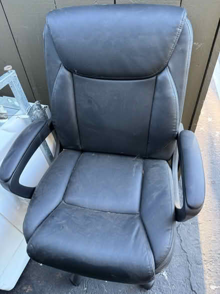 Photo of free Black vinyl office chair w armrests (1075 Valencia Avenue) #1