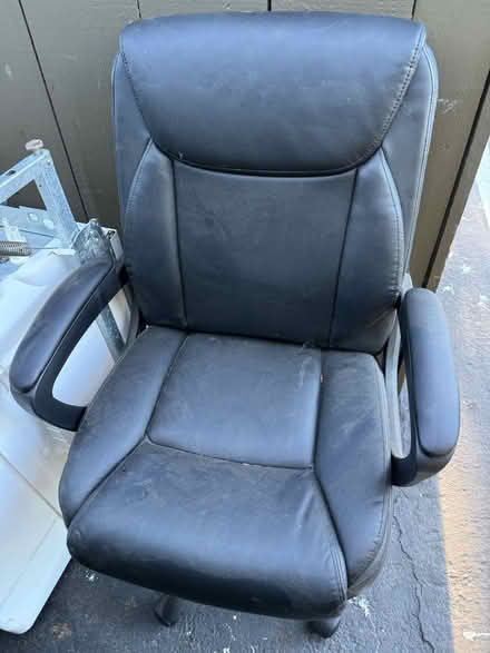 Photo of free Black vinyl office chair w armrests (1075 Valencia Avenue) #2