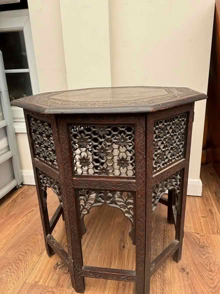 Photo of free Dark brown wooden carved octagonal table collapsible (Walton-on-Thames KT12) #1