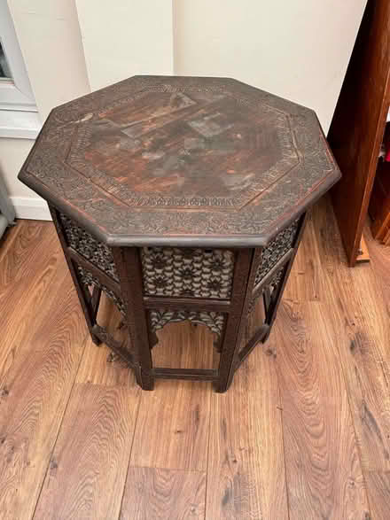 Photo of free Dark brown wooden carved octagonal table collapsible (Walton-on-Thames KT12) #2