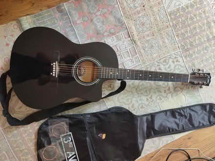 Photo of free Black guitar, with case, spare strings and plectrums (Hulme M15) #1