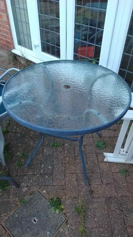 Photo of free Grey round glass garden table, bits of rust (Stopsley LU2) #1