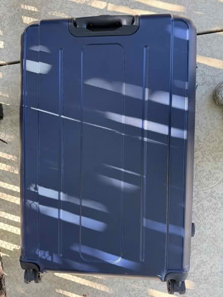 Photo of free Large plastic suitcase on casters (1075 Valencia Avenue) #4