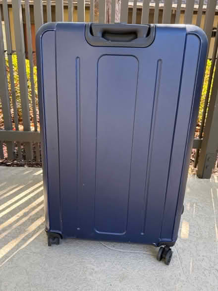 Photo of free Large plastic suitcase on casters (1075 Valencia Avenue) #3