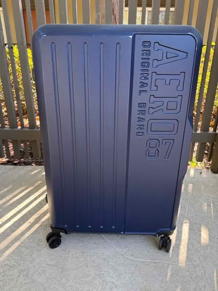 Photo of free Large plastic suitcase on casters (1075 Valencia Avenue) #2