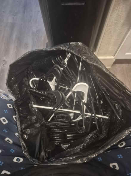 Photo of free Black trash bag full of hangers (76102) #1